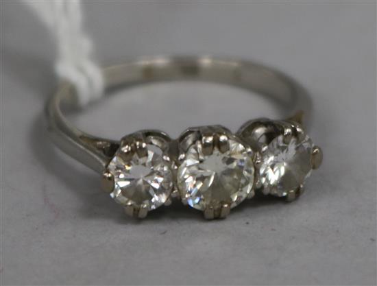 A platinum and three stone diamond ring, size L.